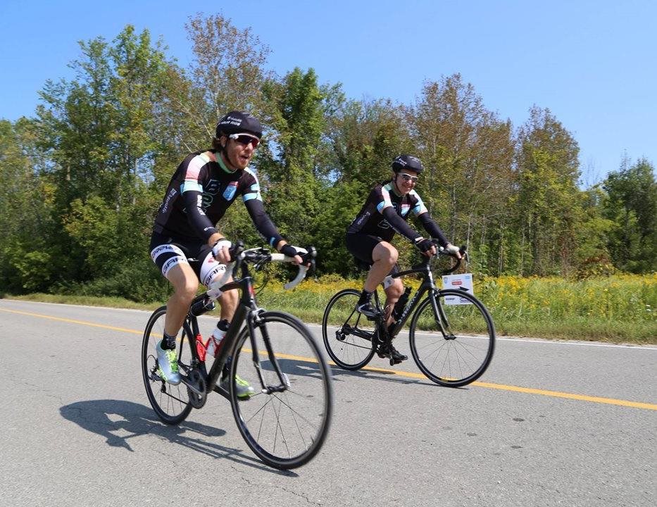 Two cyclists riding on the road