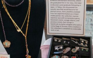 Close-up of gold necklaces and displayed pieces featured at the Artists in the Spotlight event.