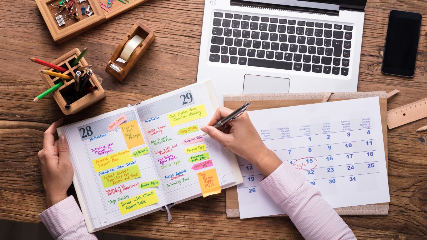 A desk with a calendar managing healthcare appointments and medical records