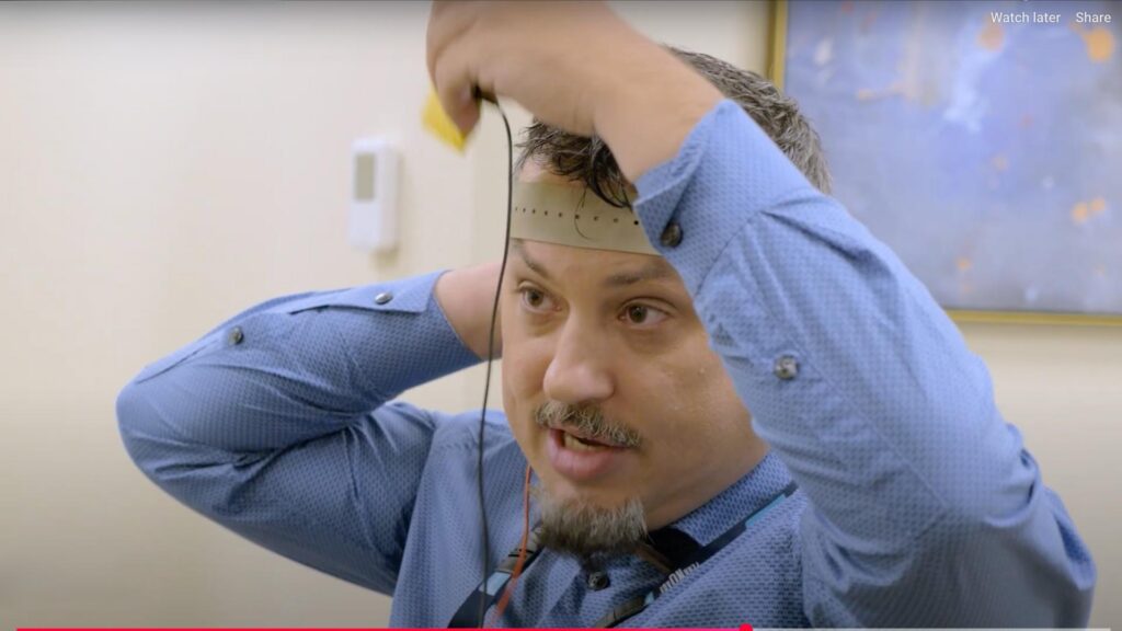 Dr. Roncero demonstrates a tCDMS head set